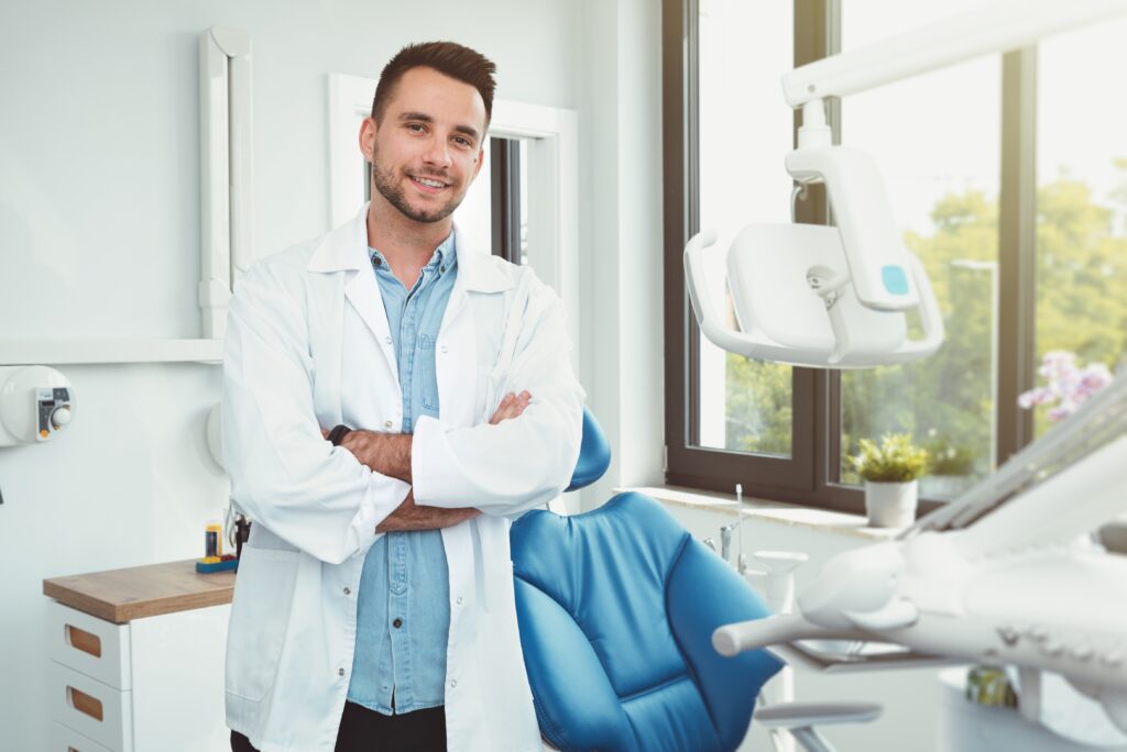 A professional young dentist in his office in Ponte Vedra Beach, providing quality dental care to patients.